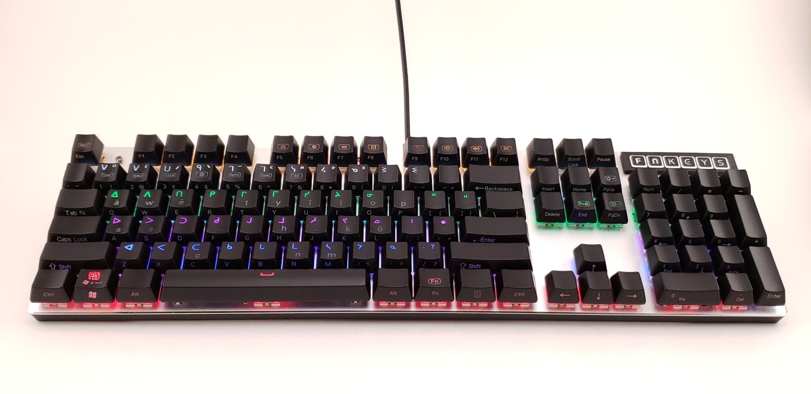 An FN Keys Plains Cree keyboard with syllabics on black backlit keys